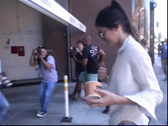 Smoking hot celebrity walks around in a flimsy shirt and tight pants