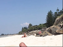 Man jerks off his little cock on a sexy woman at the beach